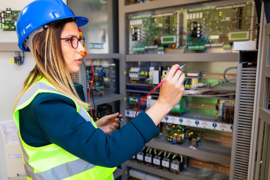 woman tradie maintenance engineer checking electrical board